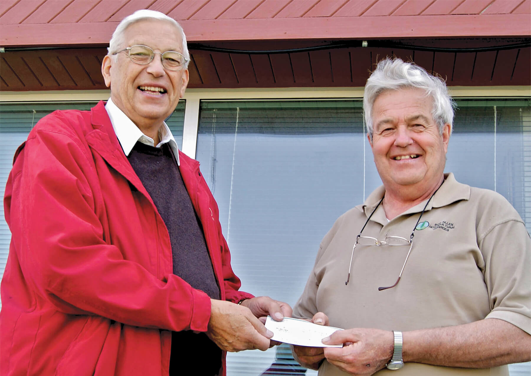 two men holding a cheque