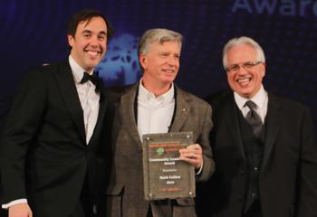 mark cullen receiving an award on stage